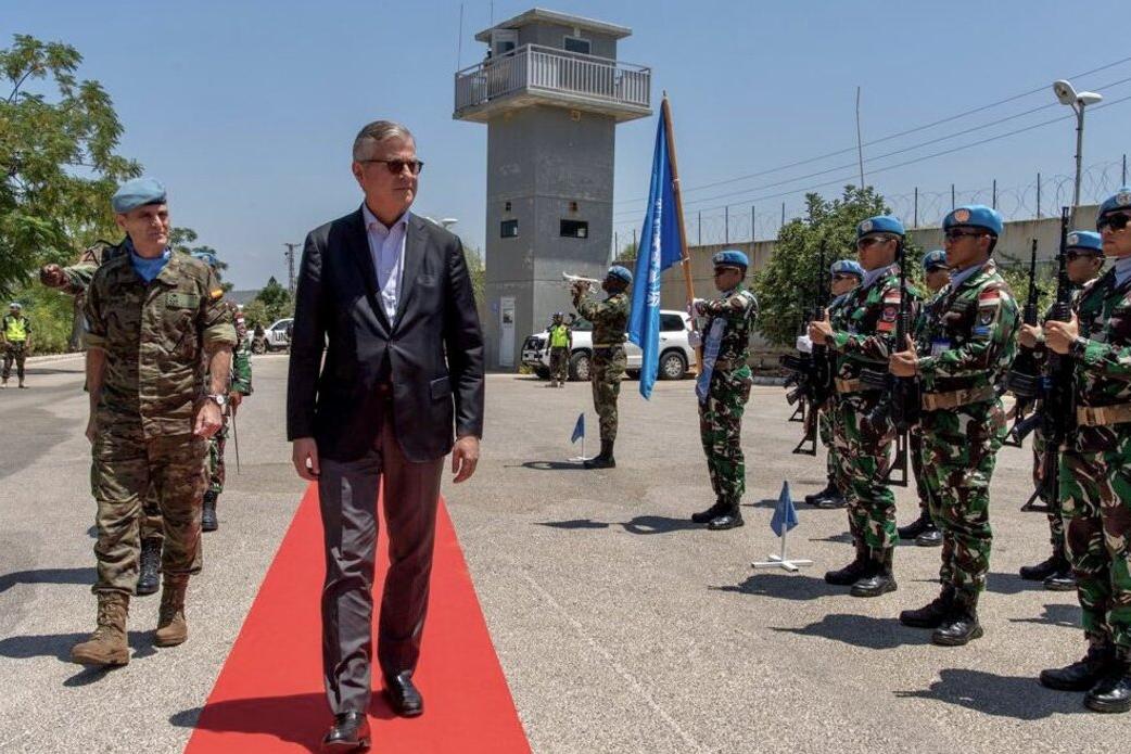 Jean-Pierre Lacroix walks alongside peacekeepers.